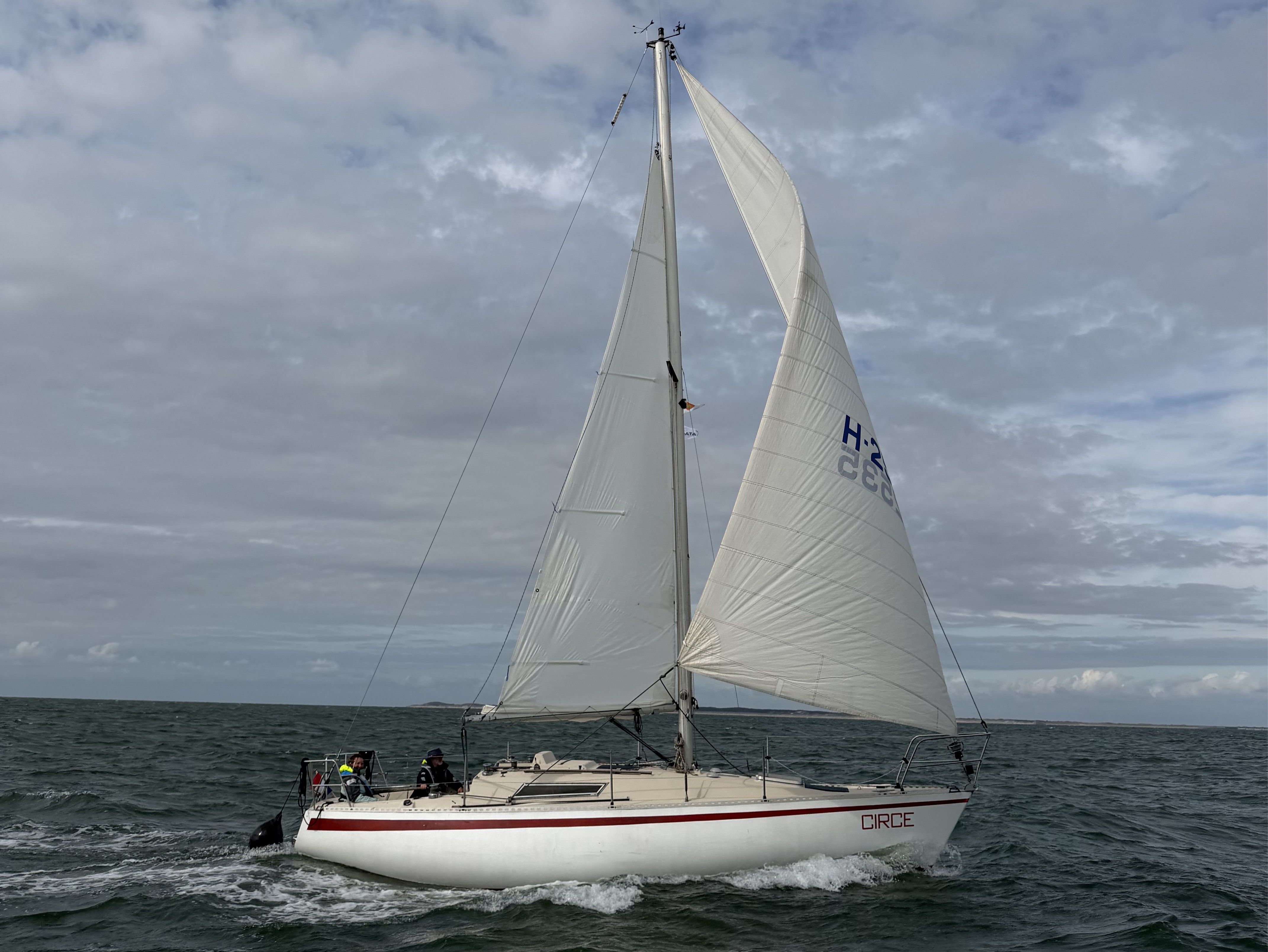 Circe, a white sailing vessel with a red stripe