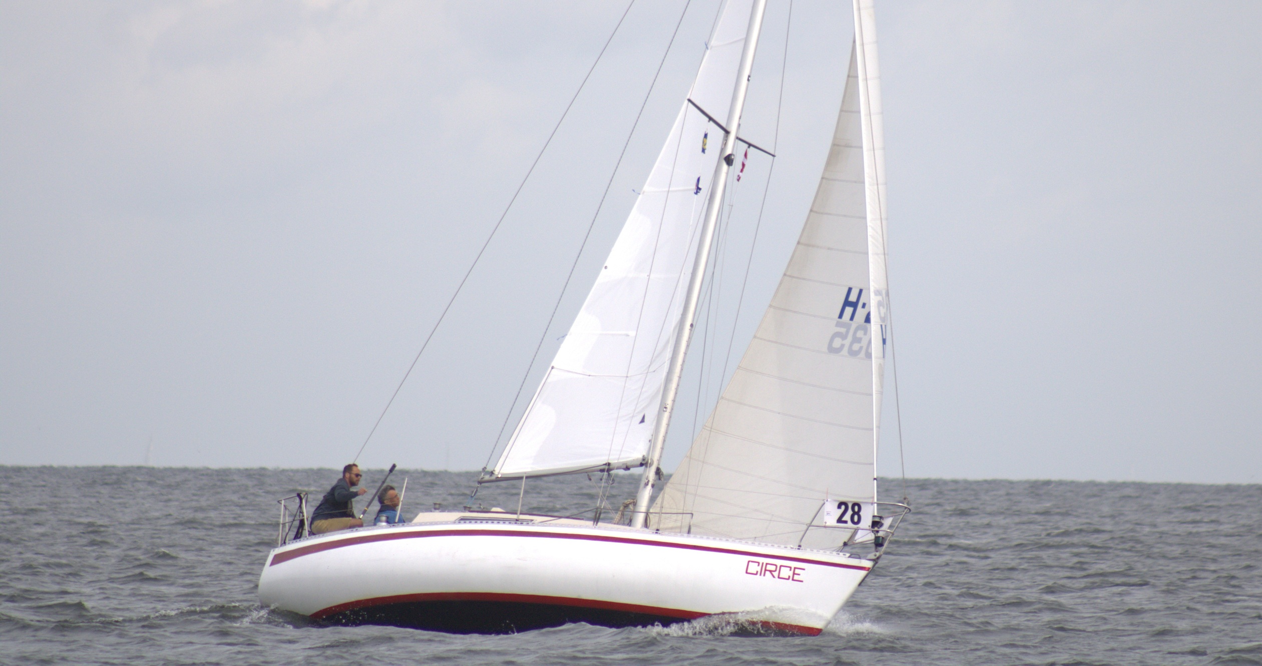 Circe, a white sailing vessel with a red stripe